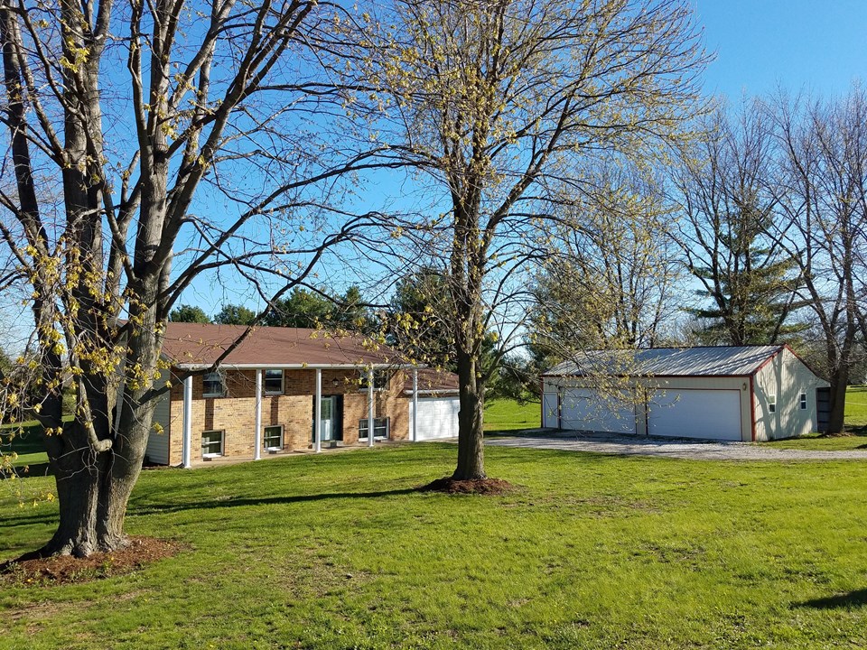 home and outbuilding sit on 3 park-like acres.