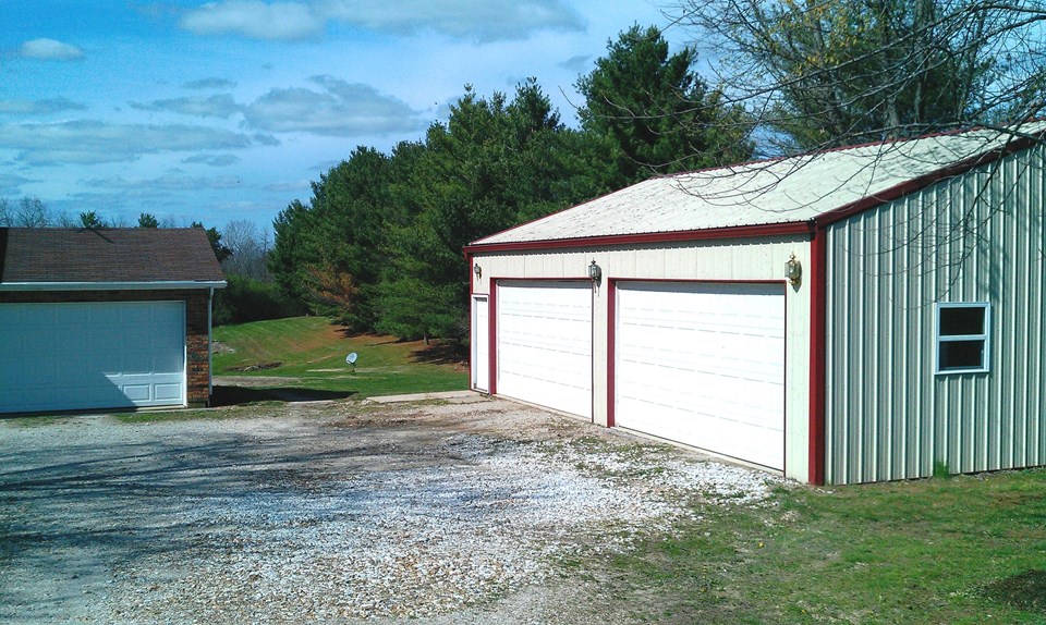 30' x 40' outbuilding with 10' ceiling, 100 amp electric, 2- 8'x16' insulated garage doors, insulated ceiling.