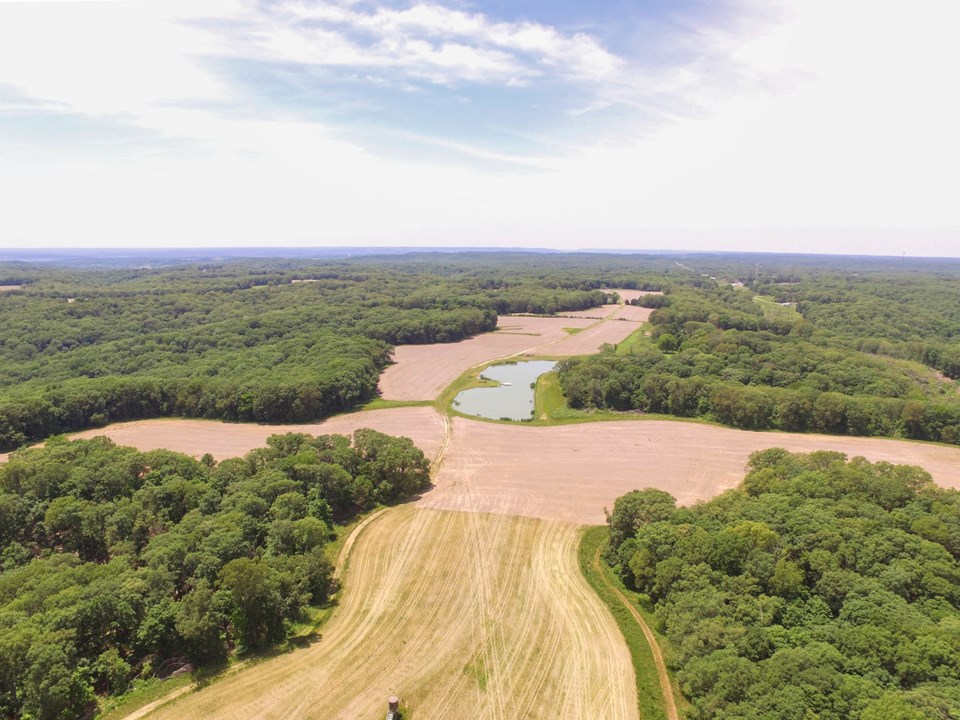 aerial view of tillable acreage, large lake and woods.