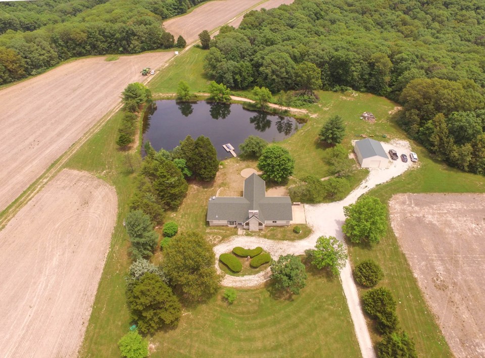 aerial of house and smaller lake.