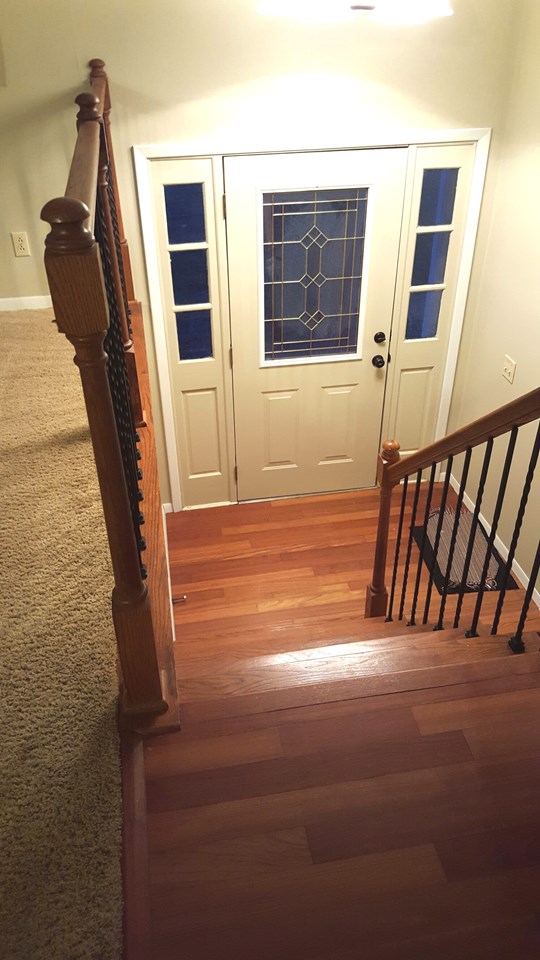 2-story entry foyer with hardwood floors.