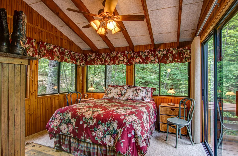master bedroom surrounded with windows.  board and batten woodwork.