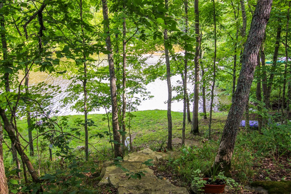 boulder staircase leads to private grassy beach.
