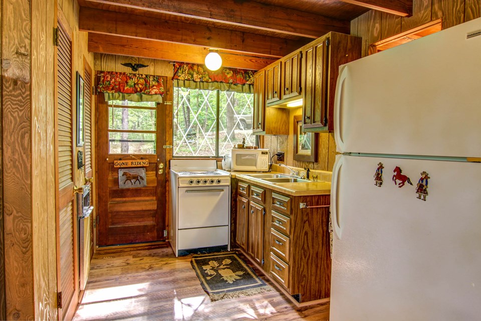 view of the kitchen with pergo-style flooring and great views while cooking indoors.