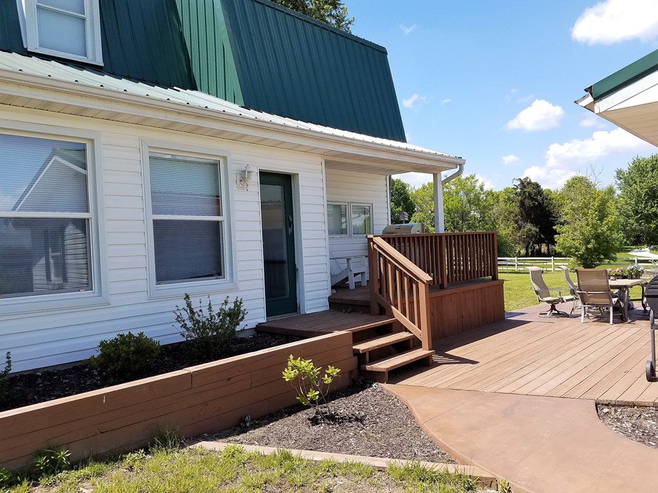 covered side porch.  glass door leads to the sunroom.