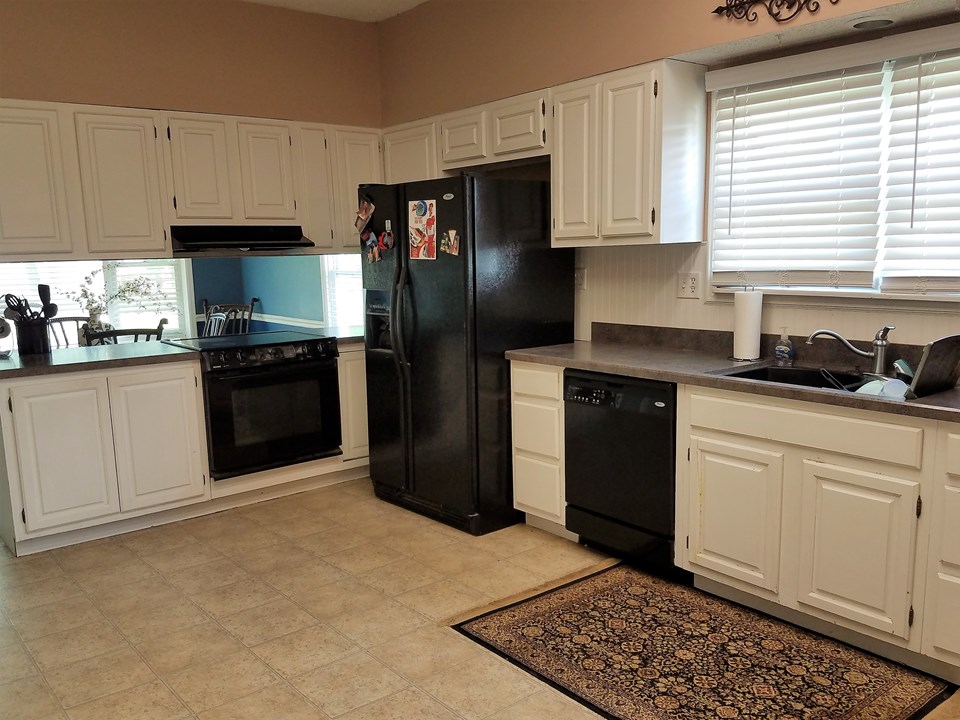 kitchen is spacious. dining room in background.