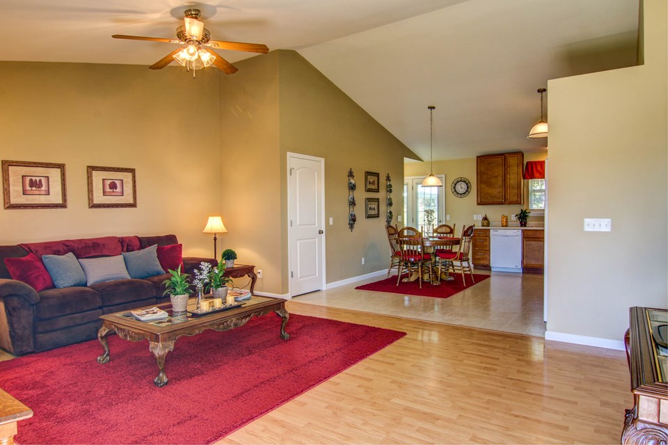 great room to the kitchen.  notice the vaulted ceiling and laminate flooring.